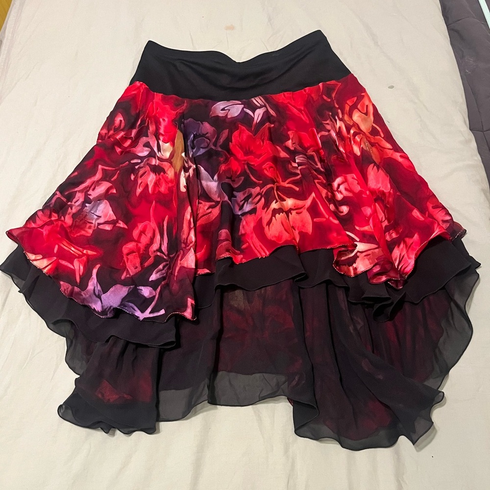 Red and black floral skirt with a flowy, asymmetrical design and fairy hem